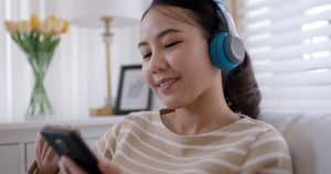 happy woman listening to internet radio on her phone.